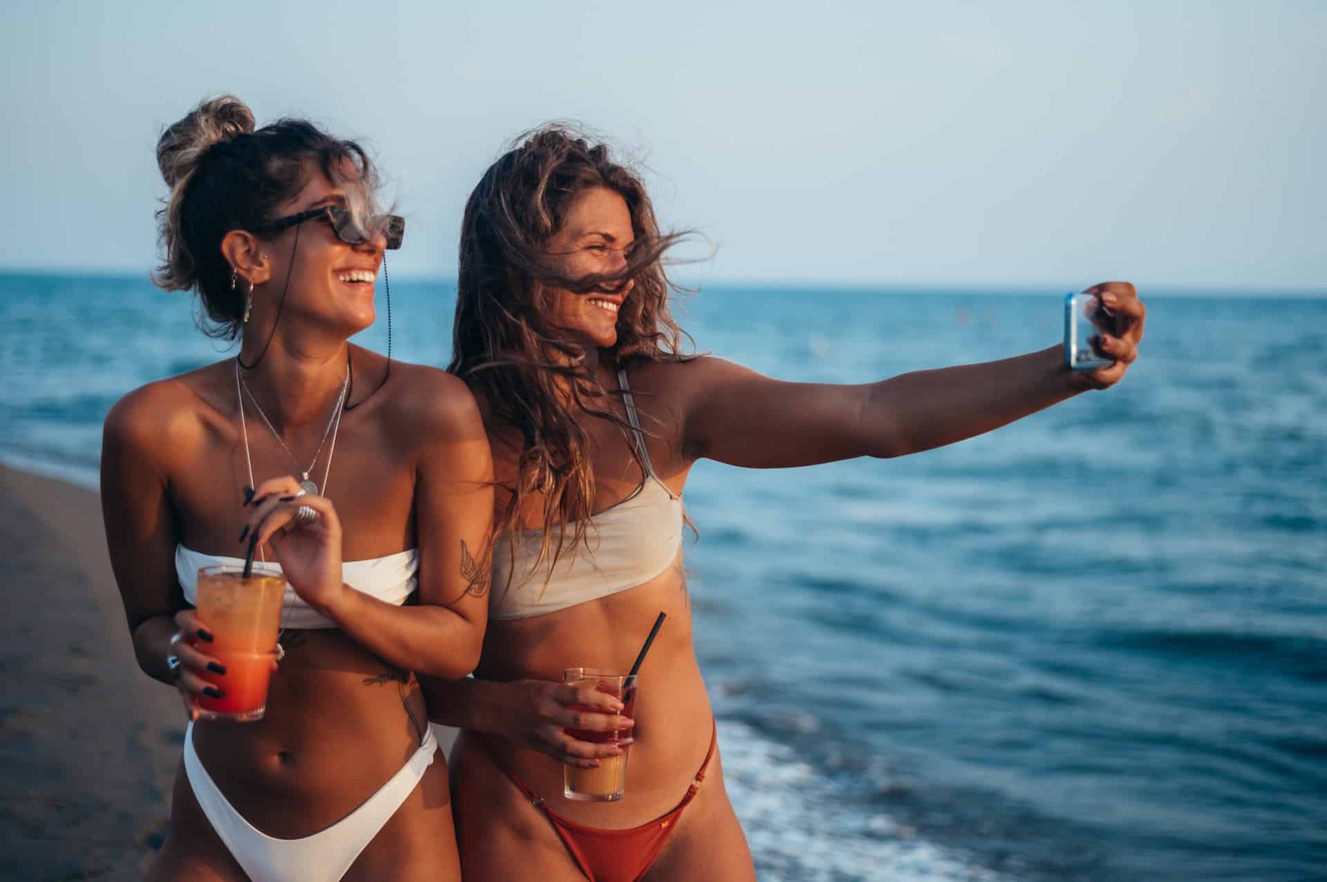 Attractive,Friends,Enjoying,Vacation,Together,And,Taking,Selfie,On,The