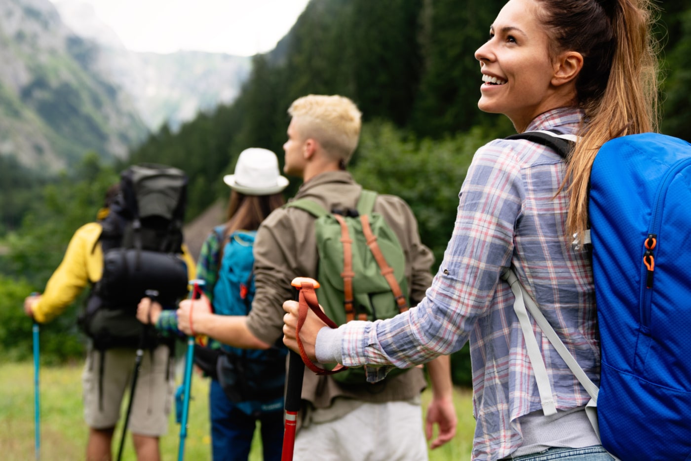 Group,Of,Friends,With,Backpacks,Doing,Trekking,Excursion,On,Mountain