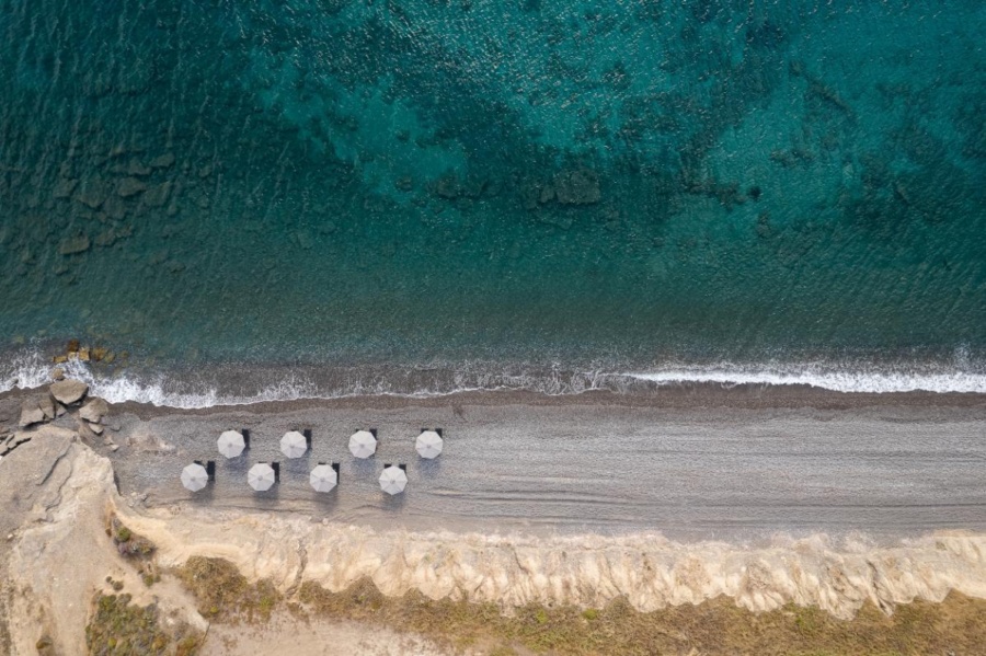 The sunbeds and umbrellas lining Koia Beach, one of the best beaches in Kos to explore.